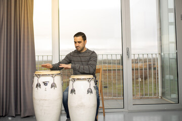 man playing musical instrument percussion congas