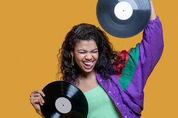 Cute dark-haired young girl holding records and feeling gorgeous