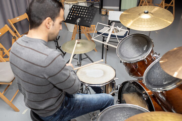 man playing musical instrument percussion drums