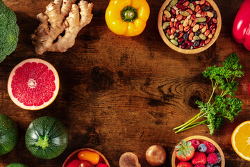 Vegan food frame with a place for text. Healthy superfoods, shot from above on a dark rustic wooden background