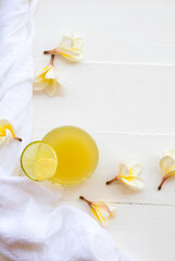 herbal healthy drinks ginger ,lemon cocktail water with flower frangipani decoration flat lay style...