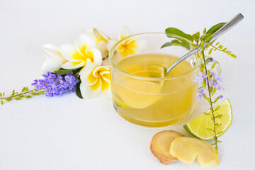 herbal healthy drinks ginger ,lemon cocktail water with purple flower ,frangipani decoration flat lay style on background white 