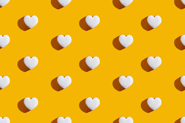 Heart pattern. Yellow seamless background. Valentine Day. Romantic greeting card. White love symbol...