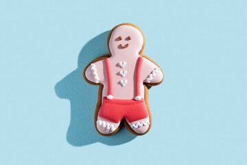 Pretty festive bakery. Valentines day pastry gift. Lovely cookies. Homemade white icing red shorts smiling gingerbread man isolated on blue pastel.