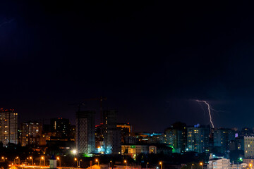 Thunder, lighting and storm in dark night sky above city