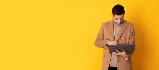 young man with laptop isolated on background