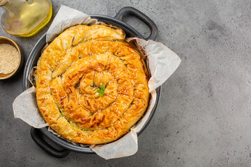 Rolled Burek - savoury pie foth feeling, decorated with sesam seedes. Top view.