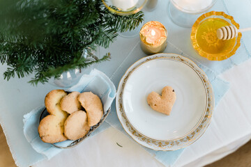 Top view of tablescape wth decoration and love heart cookie. Valentines or Christmas holiday
