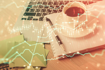 Double exposure of forex chart drawing and desktop with coffee and items on table background. Concept of financial market trading