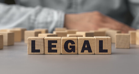 The word LEGAL made from wooden cubes. Shallow depth of field on the cubes