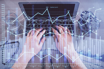 Multi exposure of man's hands typing over computer keyboard and forex graph hologram drawing. Top view. Financial markets concept.