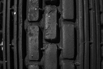 Close up of a protector of an automobile tire cover, tire tread cover pattern, texture of rubber on wheels, macro background volume black