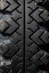 Close up of a protector of an automobile tire cover, tire tread cover pattern, texture of rubber on wheels, macro background volume black
