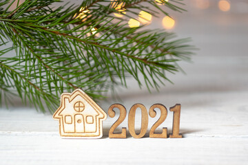 Fototapeta na wymiar New Year composition with the numbers 2021 and a small house on blurred bokeh background. Stay at home concept.