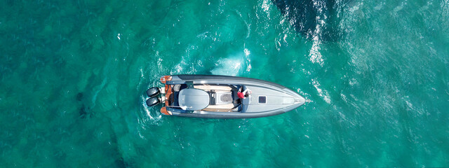 Aerial drone ultra wide top view panoramic photo of luxury inflatable rib speed boat anchored in...