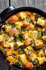 Italian strata on a black baking dish, top view