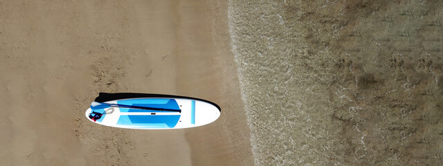 Aerial drone top down ultra wide photo of Stand Up Paddle surf board or SUP board as seen in...