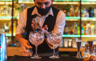 Barman making cocktail at night club