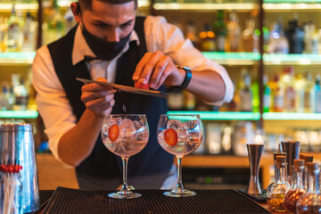 Barman making cocktail at night club