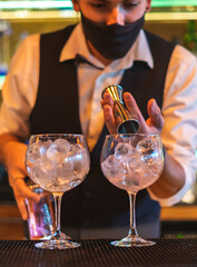 Barman making cocktail at night club