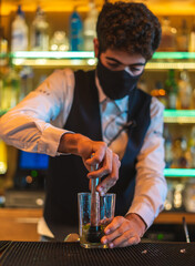 Barman making cocktail at night club