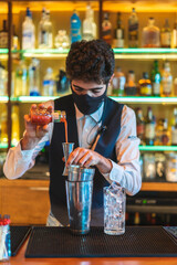 Barman making cocktail at night club