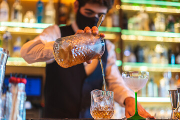 Barman making cocktail at night club