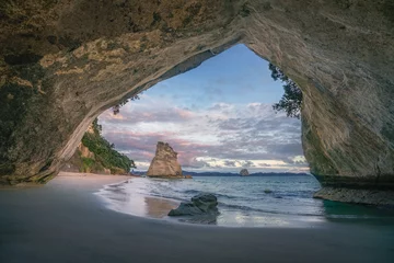 Fototapeten view from the cave at cathedral cove beach at sunrise,coromandel,new zealand © Christian B.
