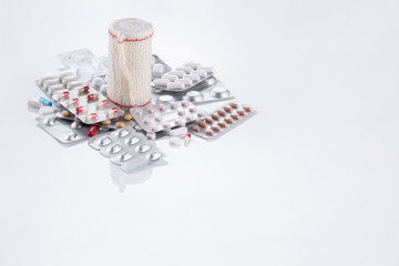 pills and band on white background