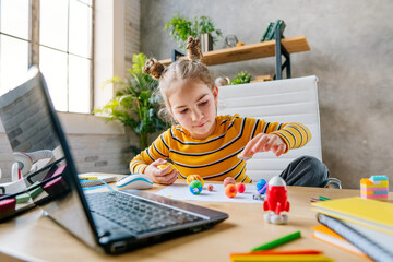 Girl using laptop to study online planets of Solar system