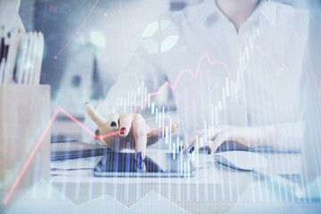 Double exposure of forex chart sketch hologram and woman holding and using a mobile device. Financial market concept.