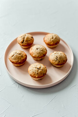 Chocolate banana muffins on a round pink dish