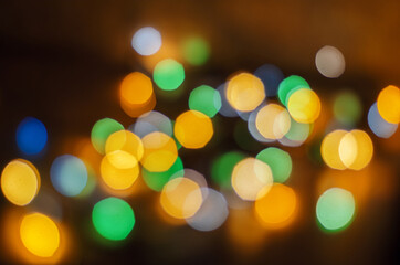 Obraz premium blurred multicolored christmas lights from garland