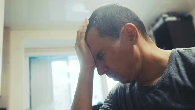 man tired depression at work indoors is sick with coronavirus. sick senior. tired man has a headache. dad got tired depressed covid 19