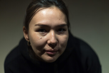 beautiful girl posing in front of the camera on a dark background