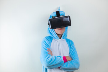 bored little girl in a pajamas with a virtual reality glasses. portrait  child on white background