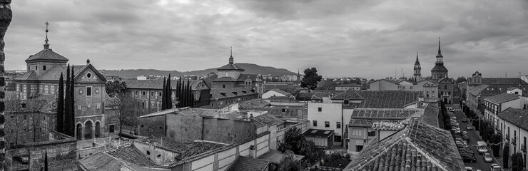 Panoramic view of several old buildings in the historic center of Alcalá de Henares. Black and white.