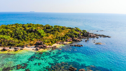 Aerial view of beautiful landscape, tourism boats, and people swimming on the sea and beach on May Rut island (a tranquil island with beautiful beach) in Phu Quoc, Kien Giang, Vietnam.