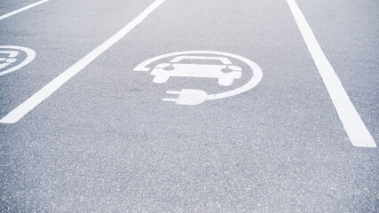 sign on the pavement charging for electric vehicles