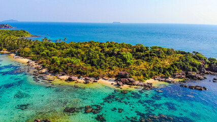 Aerial view of beautiful landscape, tourism boats, and people swimming on the sea and beach on May Rut island (a tranquil island with beautiful beach) in Phu Quoc, Kien Giang, Vietnam.