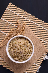Cooked brown quinoa seeds in a bowl, Top view, Healthy vegan food