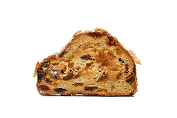 Slice of German Stollen cake, a fruit bread with nuts, spices, and dried or candied fruits with powdered sugar traditionally served during Christmas time isolated on white background