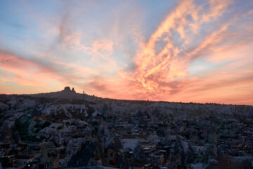 Ancient cave houses  and rock formations in Goreme, Cappadocia, Turkey at sunset