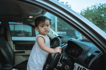 Portrait of little girl impatient on vacation by car