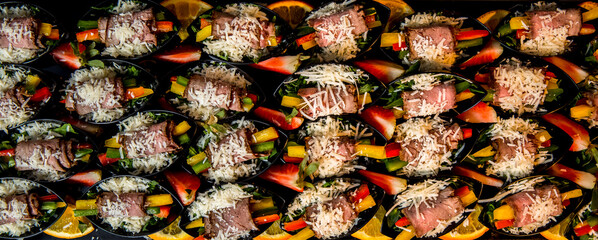 Beautifully decorated catering banquet table with different food snacks and appetizers with sandwich