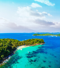 Aerial view of beautiful landscape, tourism boats, and people swimming on the sea and beach on May Rut island (a tranquil island with beautiful beach) in Phu Quoc, Kien Giang, Vietnam.