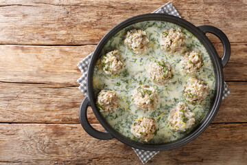 Μeatballs with rice in yogurt sauce Yuvarlakia close-up in a plate on the table. Horizontal top...