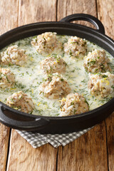 Yuvarlakia giouvarlakia is the rice and ground meat meatball served in avgolemono sauce close-up in a plate on the table. Vertical