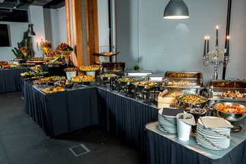 Beautifully decorated catering banquet table with different food snacks and appetizers with sandwich