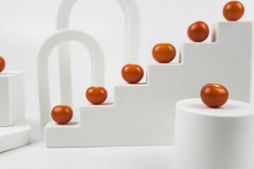 Aesthetic food photography on trendy white podium. Minimal food art still life concept.  Cherry tomatoes on white background.